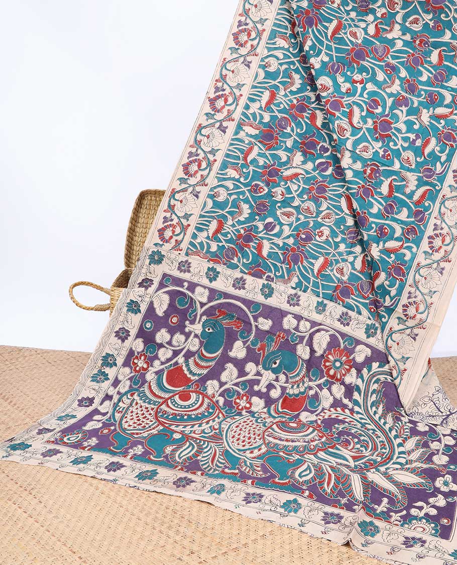Blue floral machine-printed kalamkari cotton saree, contrast floral border & peacock pallu