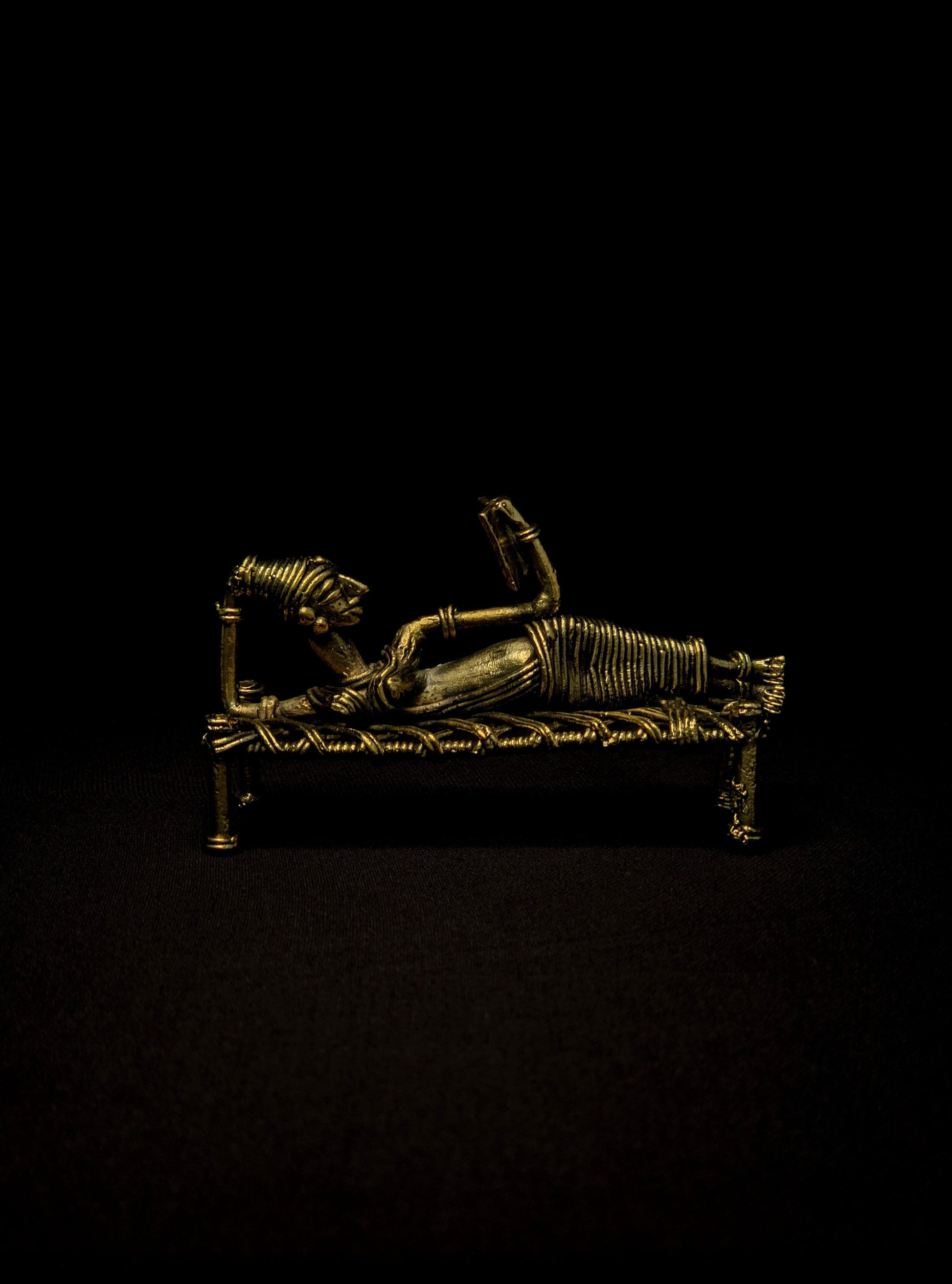 Dhokra - Tribal Lady Sleeping on Bed and Reading