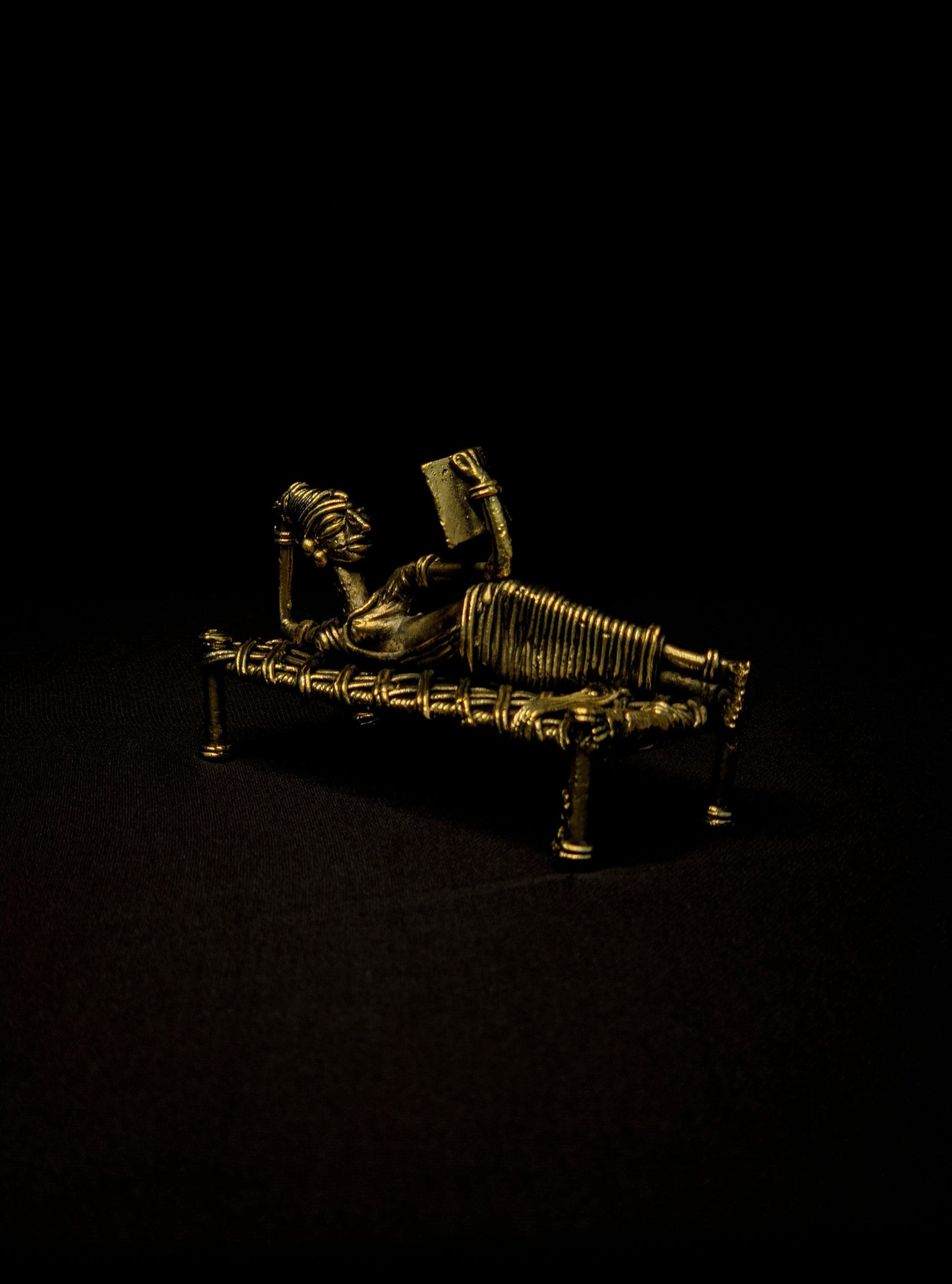 Dhokra - Tribal Lady Sleeping on Bed and Reading