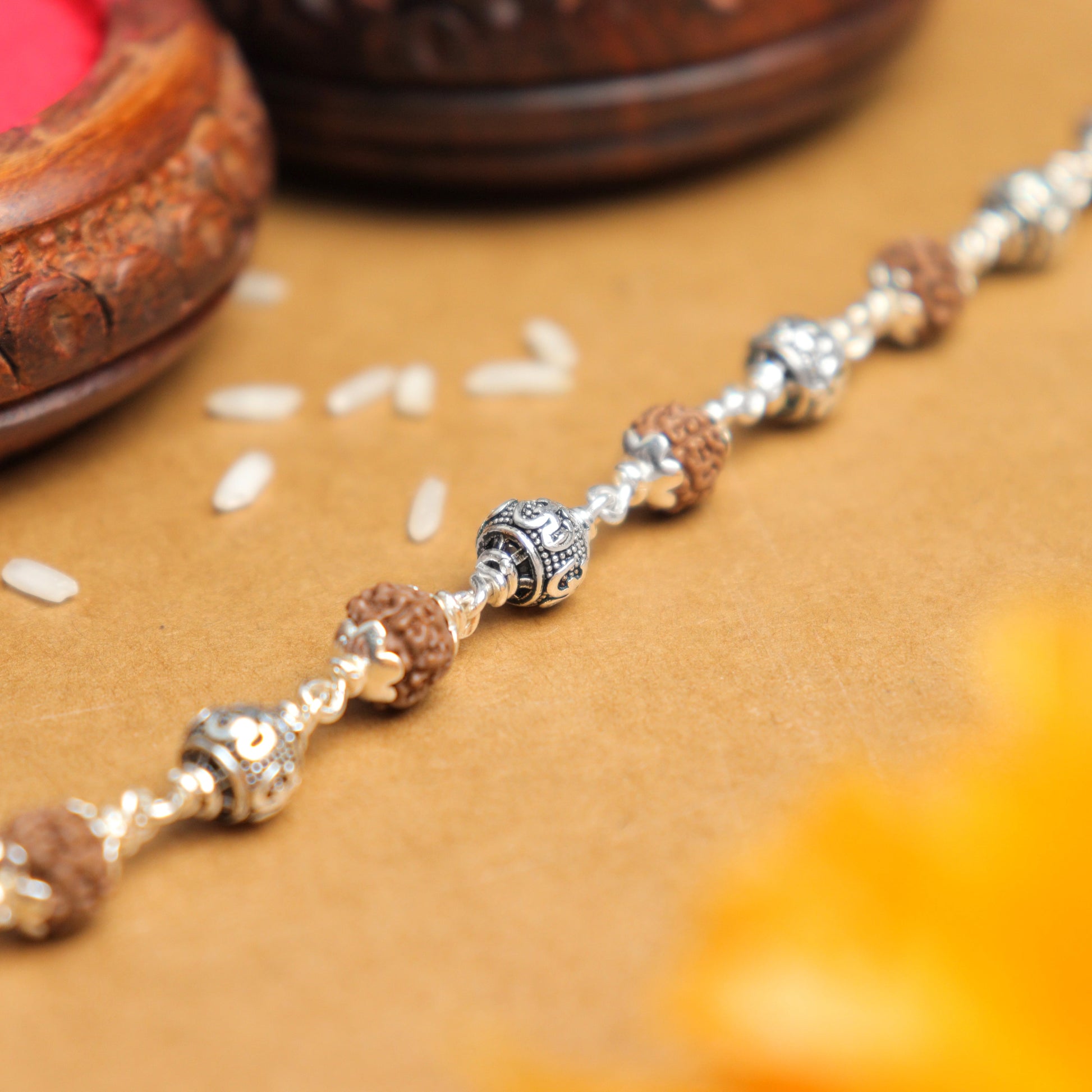 Silver Rakhi with Rudraksha and Om Beads