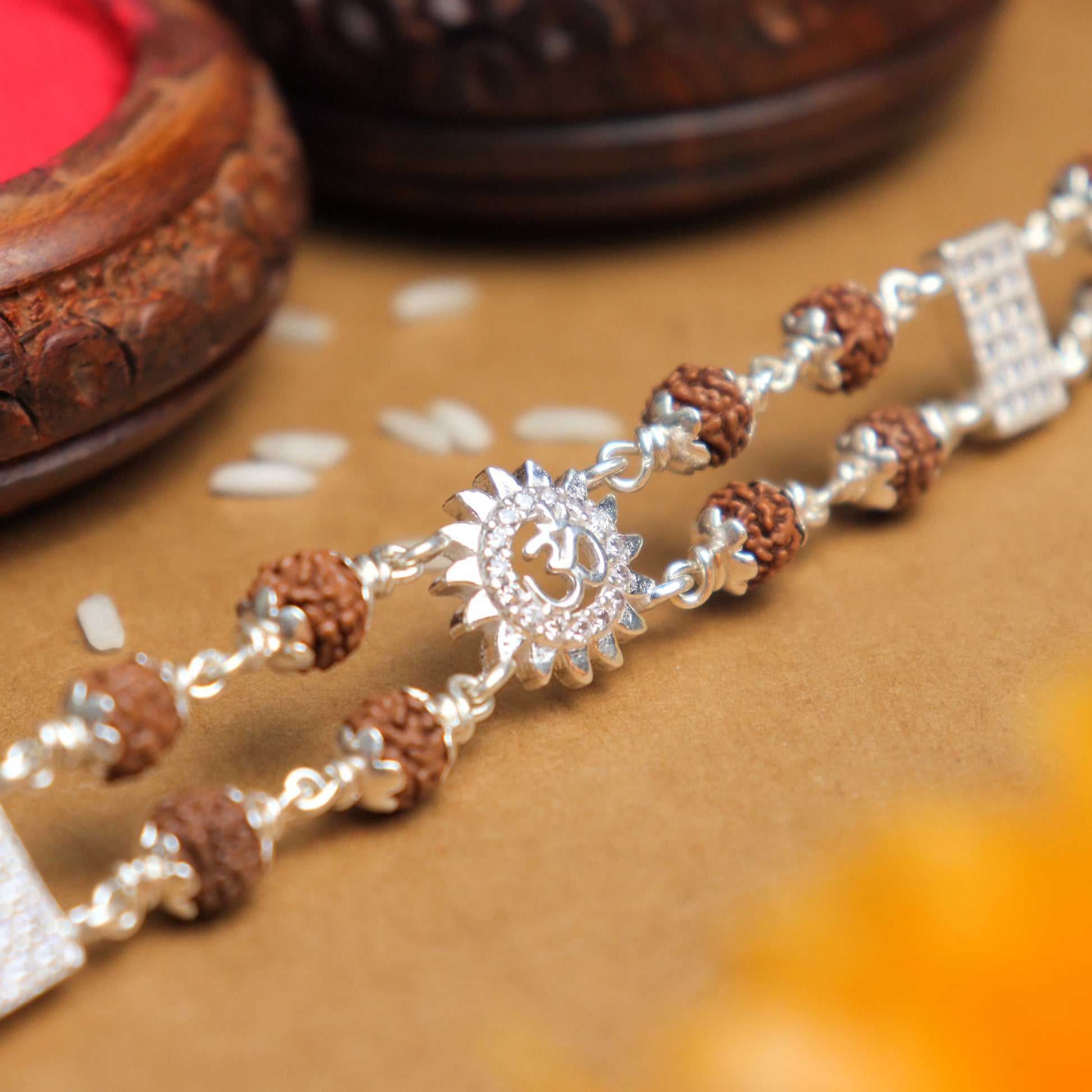 Silver Rakhi with Rudraksha, Om Flower Brooch, Double Line Bracelet