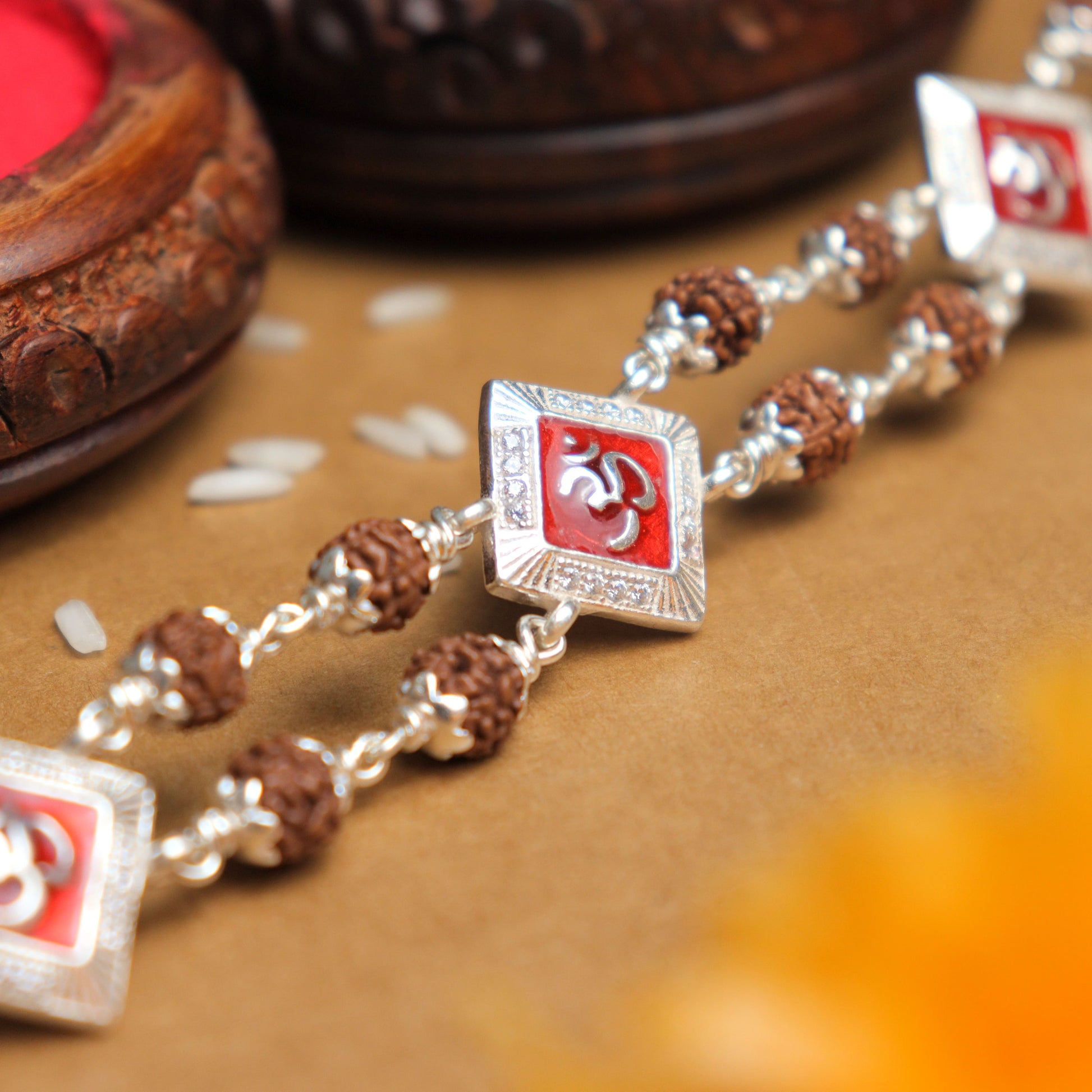 Silver Rakhi with Rudraksha, Om, and Three Rhombus Brooches, Double Line Design