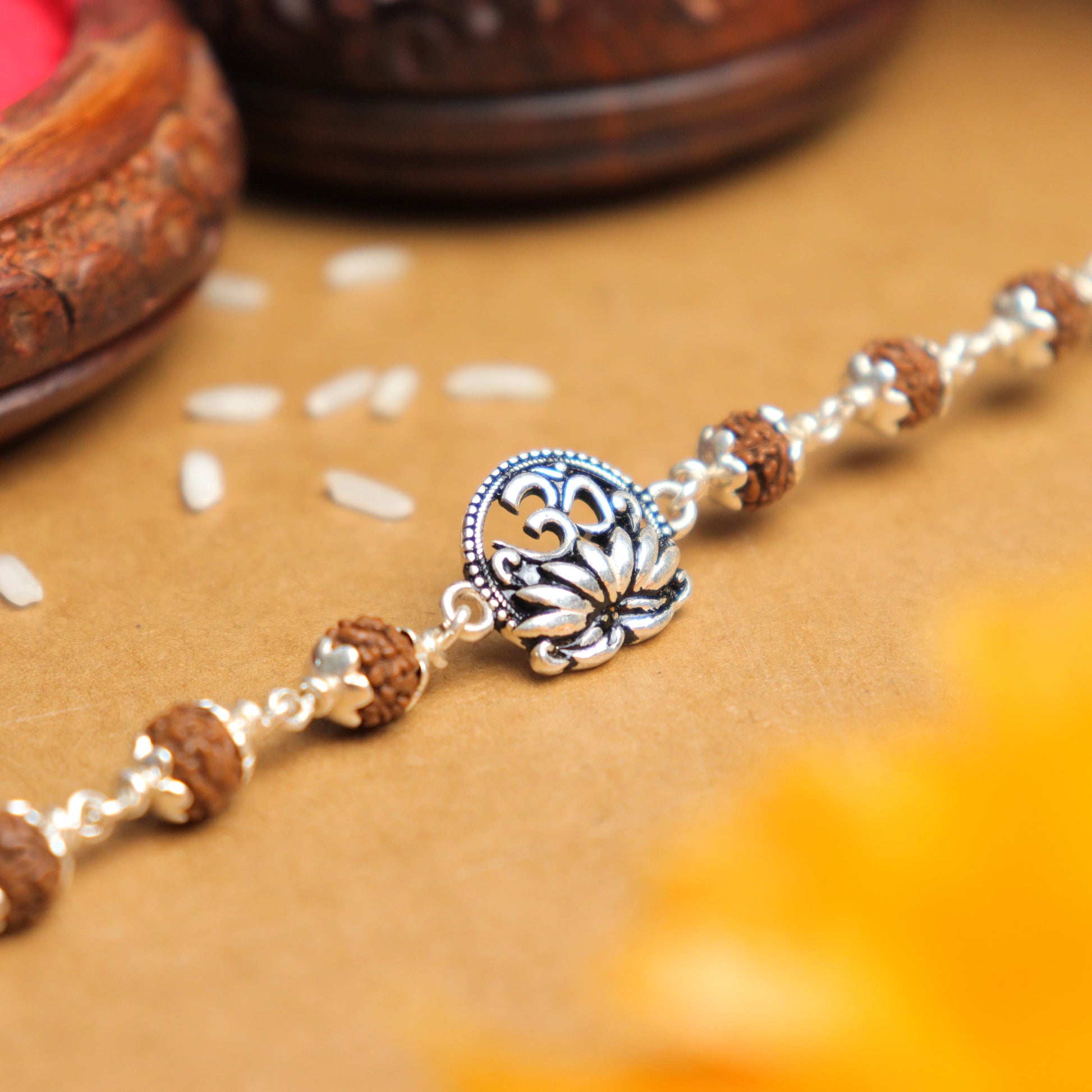 Silver Rakhi with Om and Lotus Flower and Single Line Rudraksha for Men