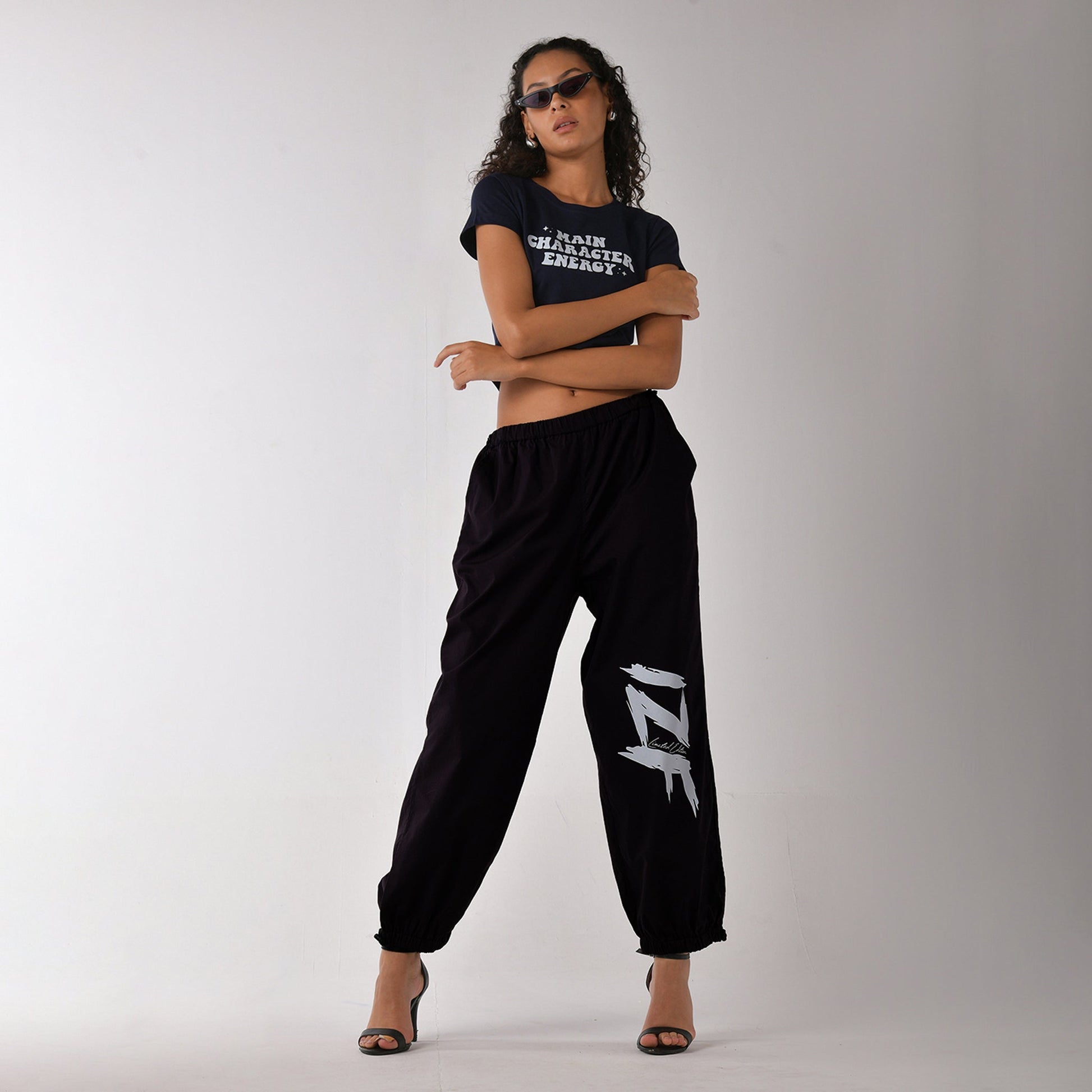 Printed "Limited edition" parachute pants for women in Black