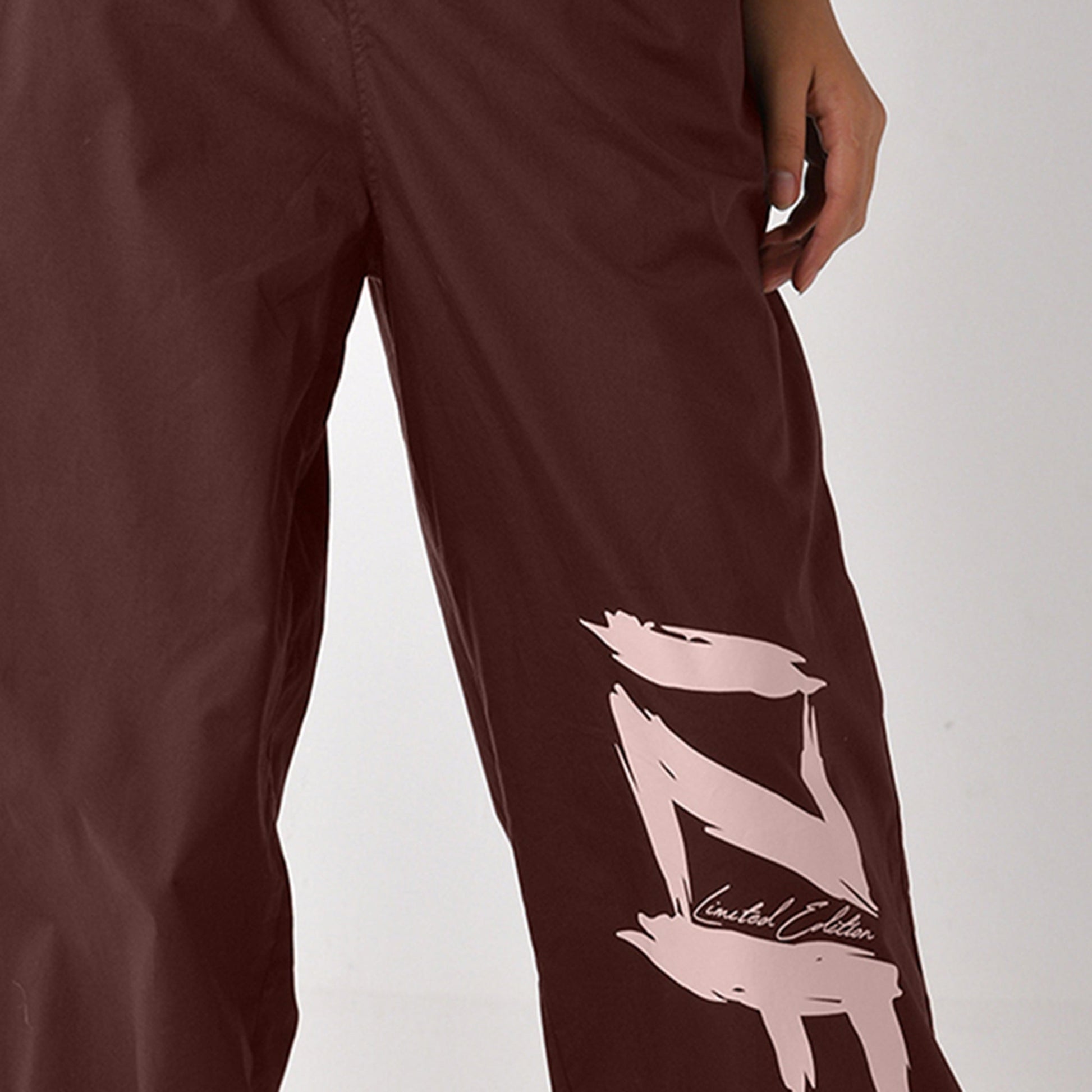 Printed "Limited edition" parachute pants for women in Brown