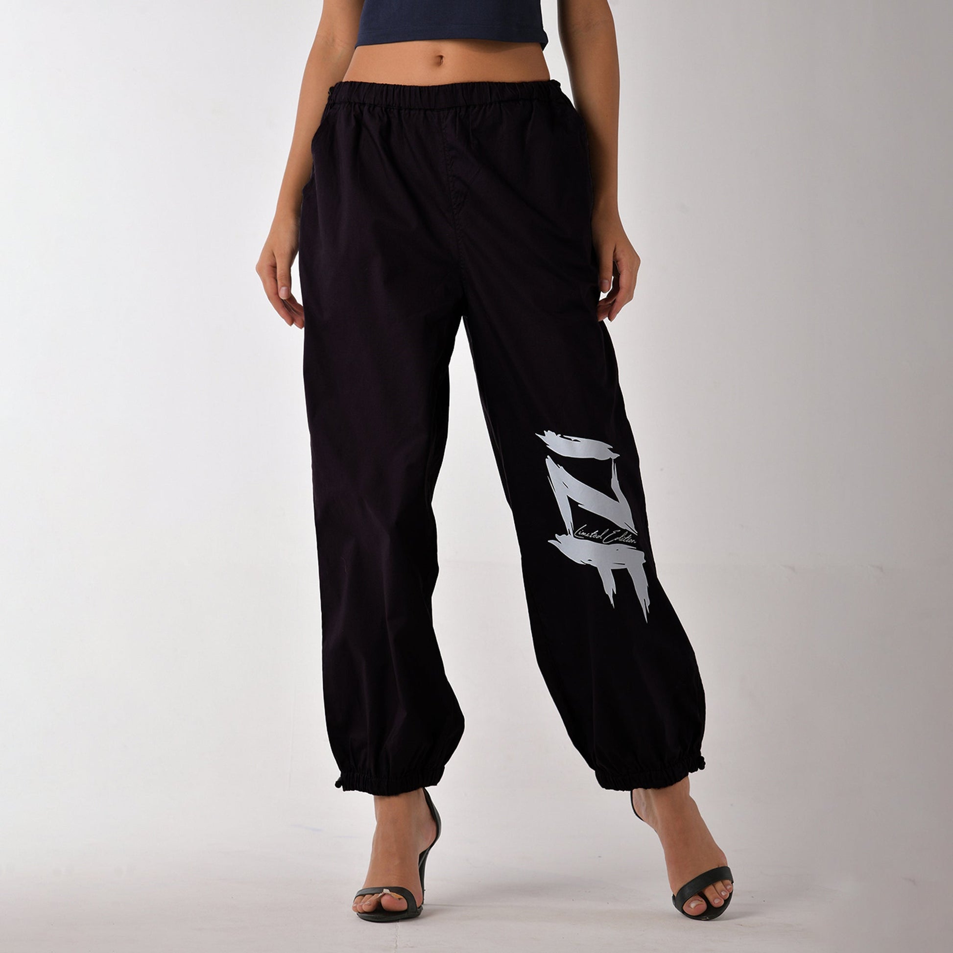 Printed "Limited edition" parachute pants for women in Black
