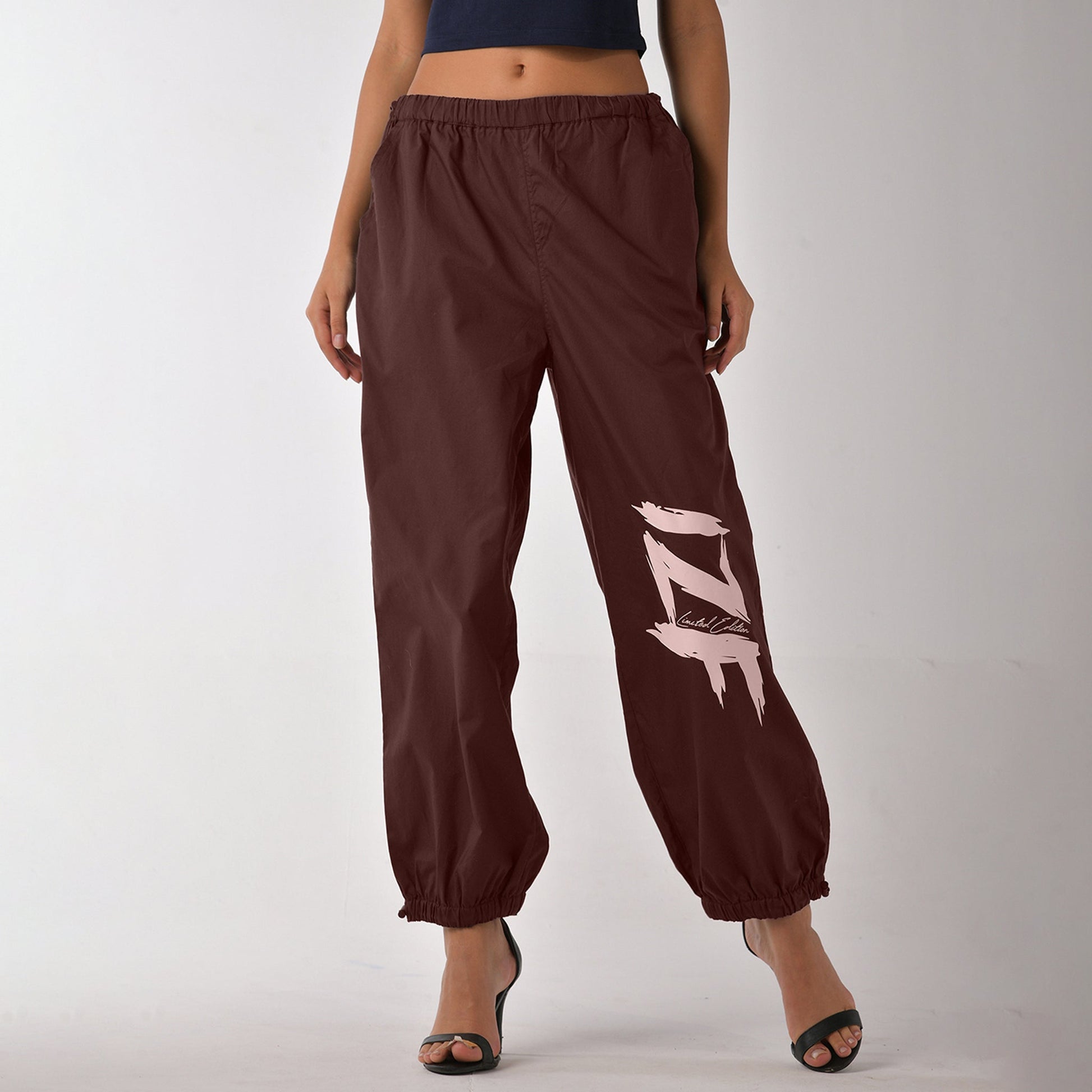 Printed "Limited edition" parachute pants for women in Brown