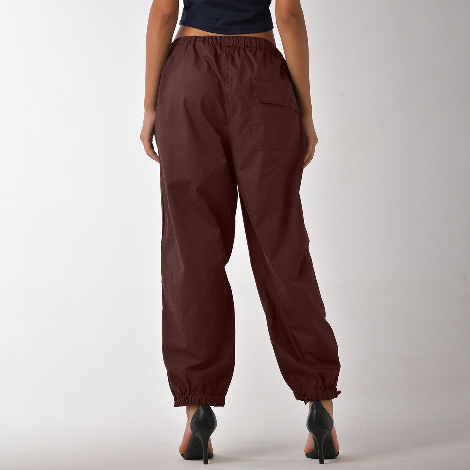 Printed "Limited edition" parachute pants for women in Brown