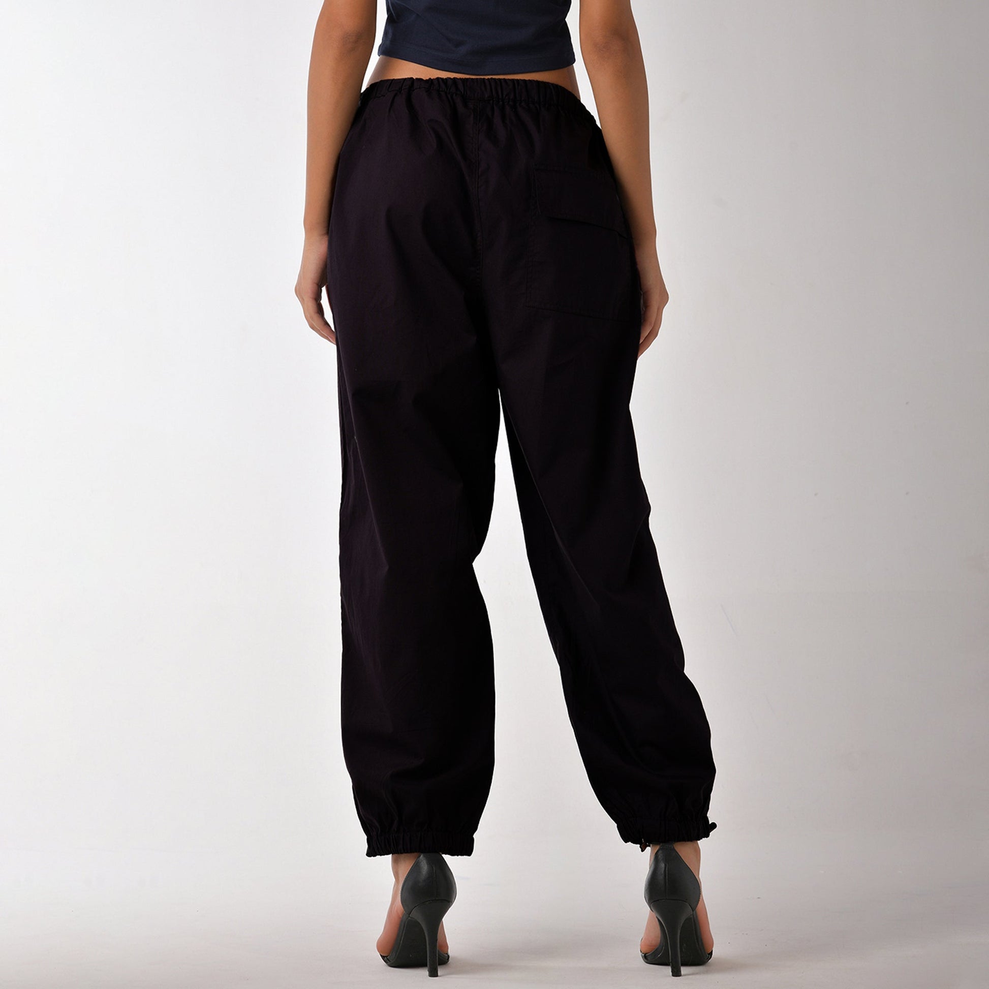 Printed "Limited edition" parachute pants for women in Black