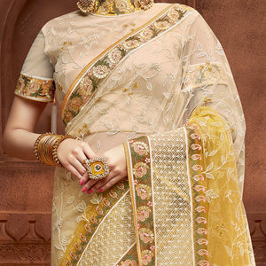 Capricious Beige & Mustard Coloured Partywear Embroidered Soft Net Saree