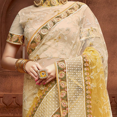 Capricious Beige & Mustard Coloured Partywear Embroidered Soft Net Saree