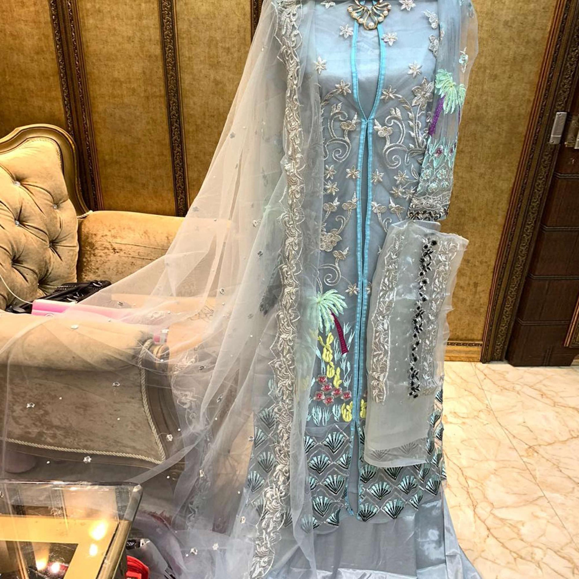 Capricious Light Blue Colored Partywear Embroidered Netted Palazzo Suit