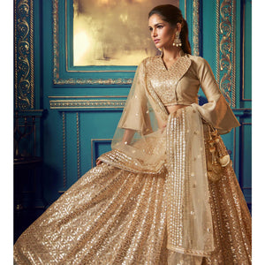 Dazzling Beige Colored Partywear Embroidered Soft Net Lehenga Choli