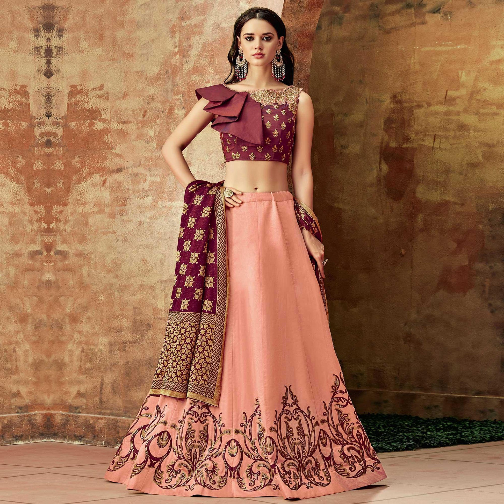 Dazzling Peach Colored Partywear Embroidered Silk Lehenga Choli