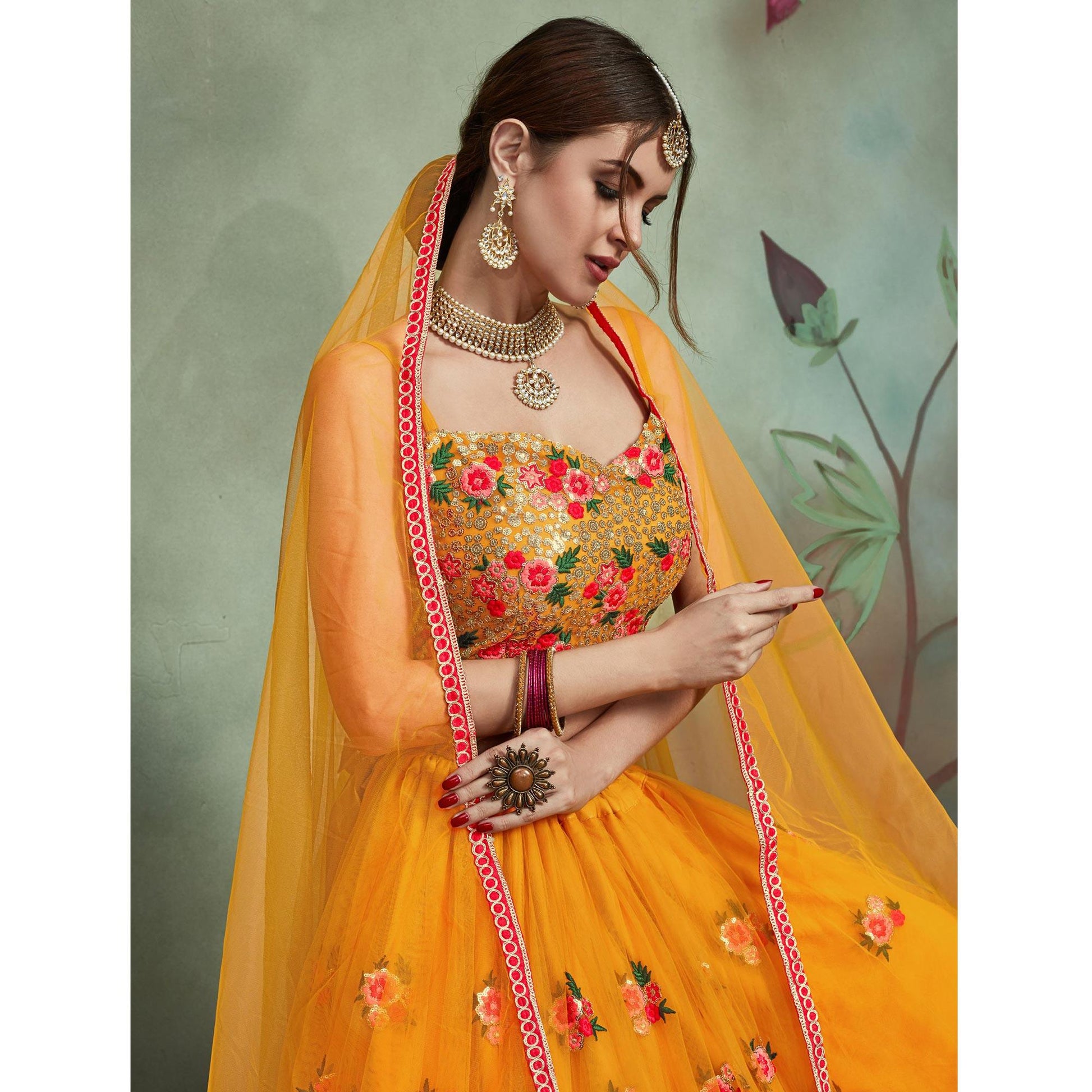 Demanding Mustard Yellow Colored Partywear Embroidered Netted Lehenga