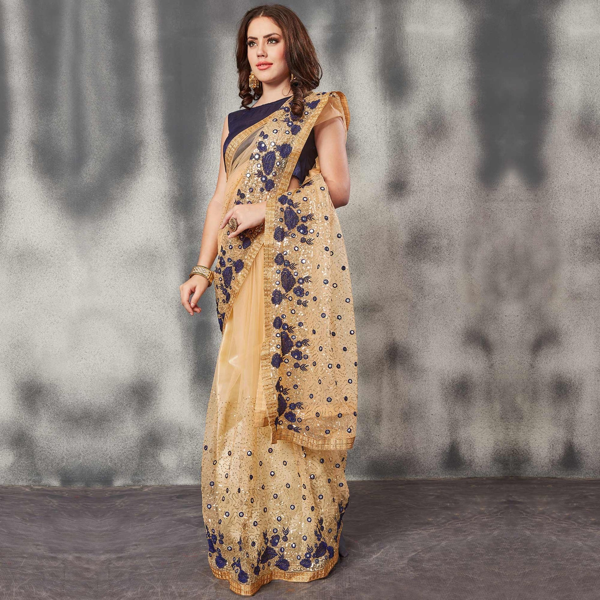 Desirable Beige Navy Blue Colored Partywear Embroidered Netted Saree
