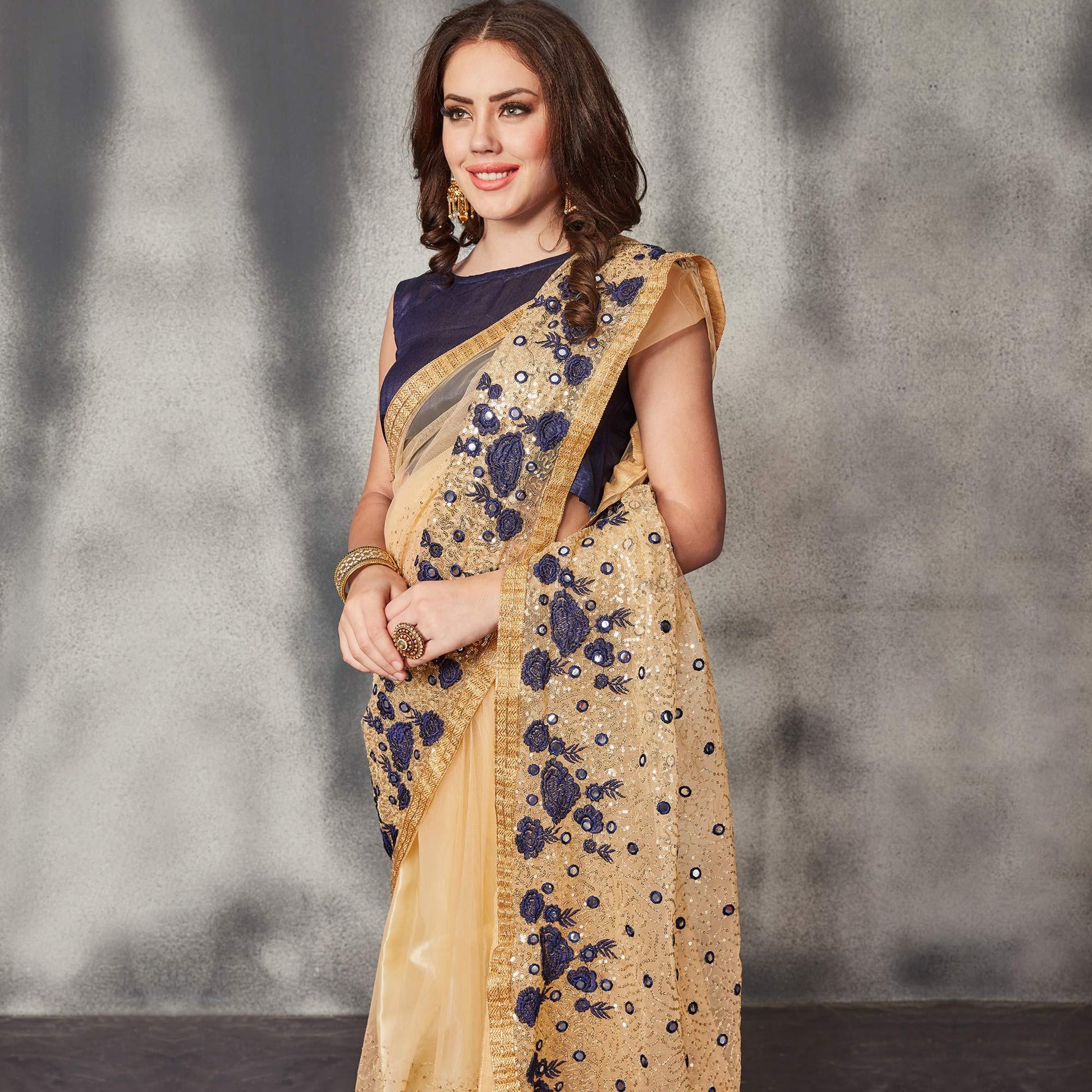 Desirable Beige Navy Blue Colored Partywear Embroidered Netted Saree