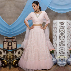 Desirable Pastel Peach Colored Party Wear Embroidered Net Lehenga Choli