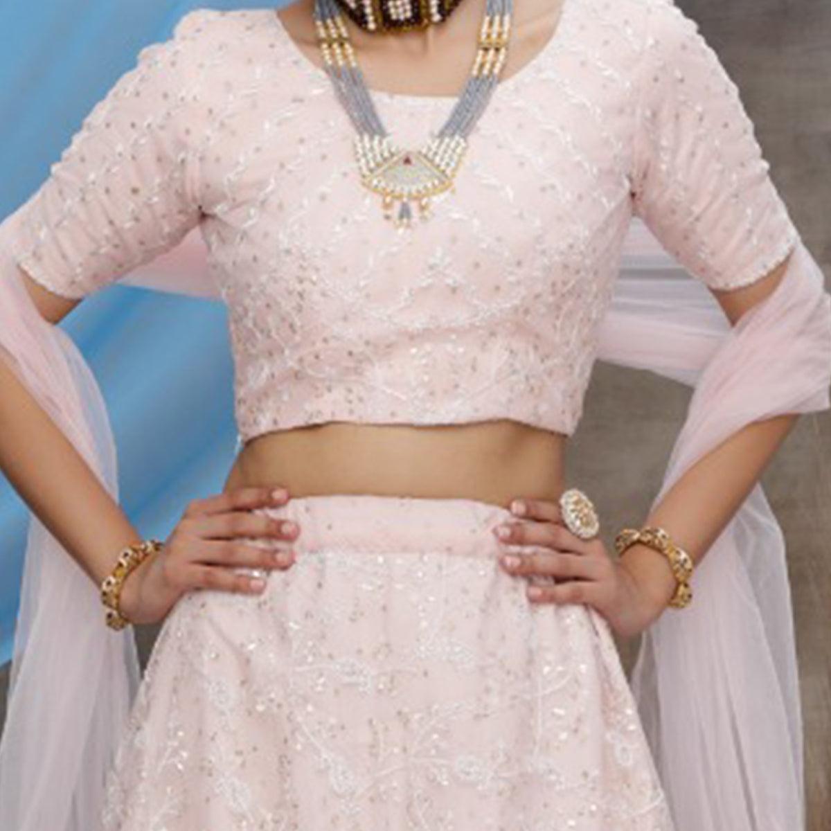 Desirable Pastel Peach Colored Party Wear Embroidered Net Lehenga Choli