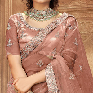 Dusty Pink Partywear Multi Sequins Embroidered Net Lehenga Choli