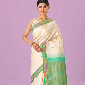 Cream Handloom Kanchipuram Silk Saree With Zari Buttas & Contrast Border