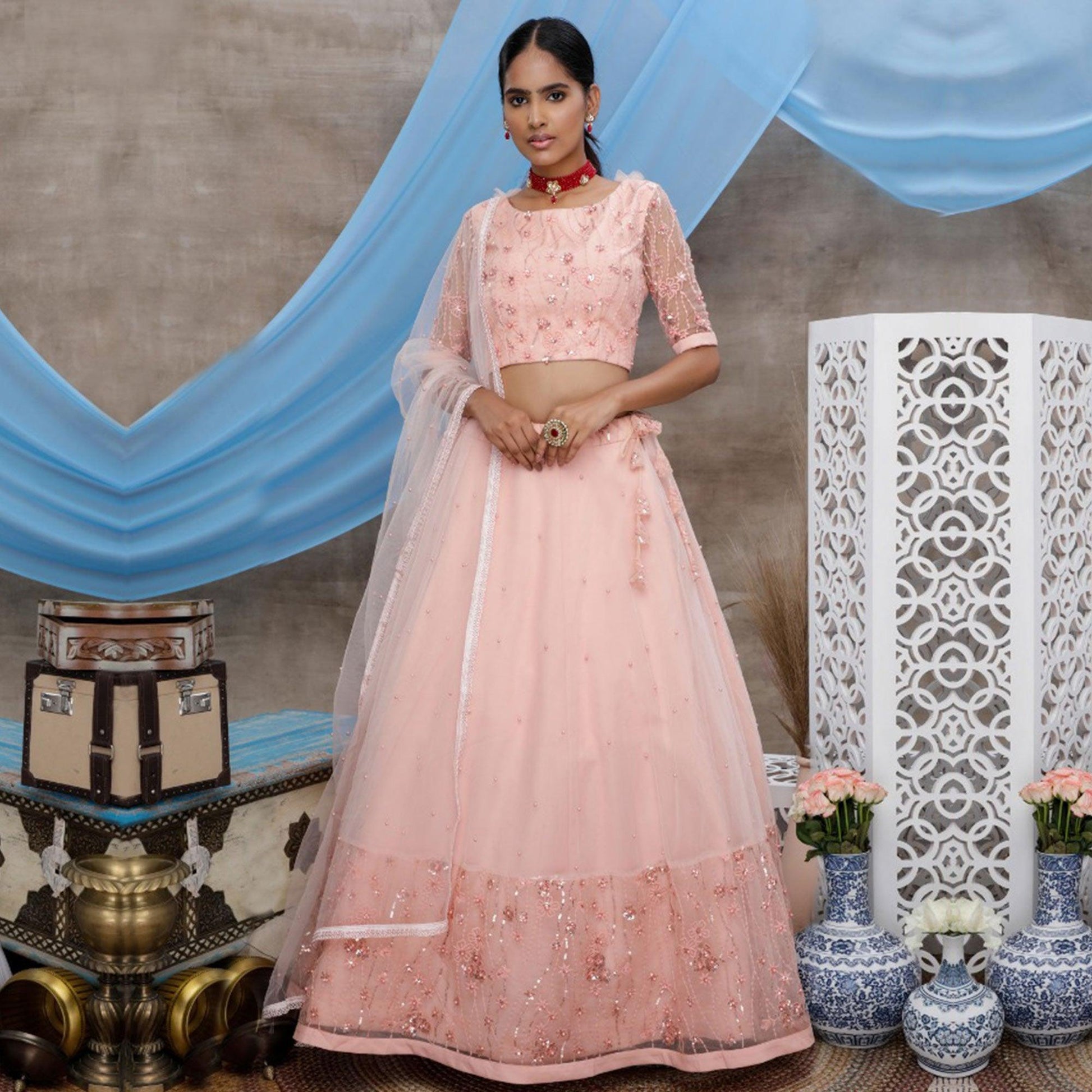 Elegant Peach Colored Party Wear Embroidered Net Lehenga Choli