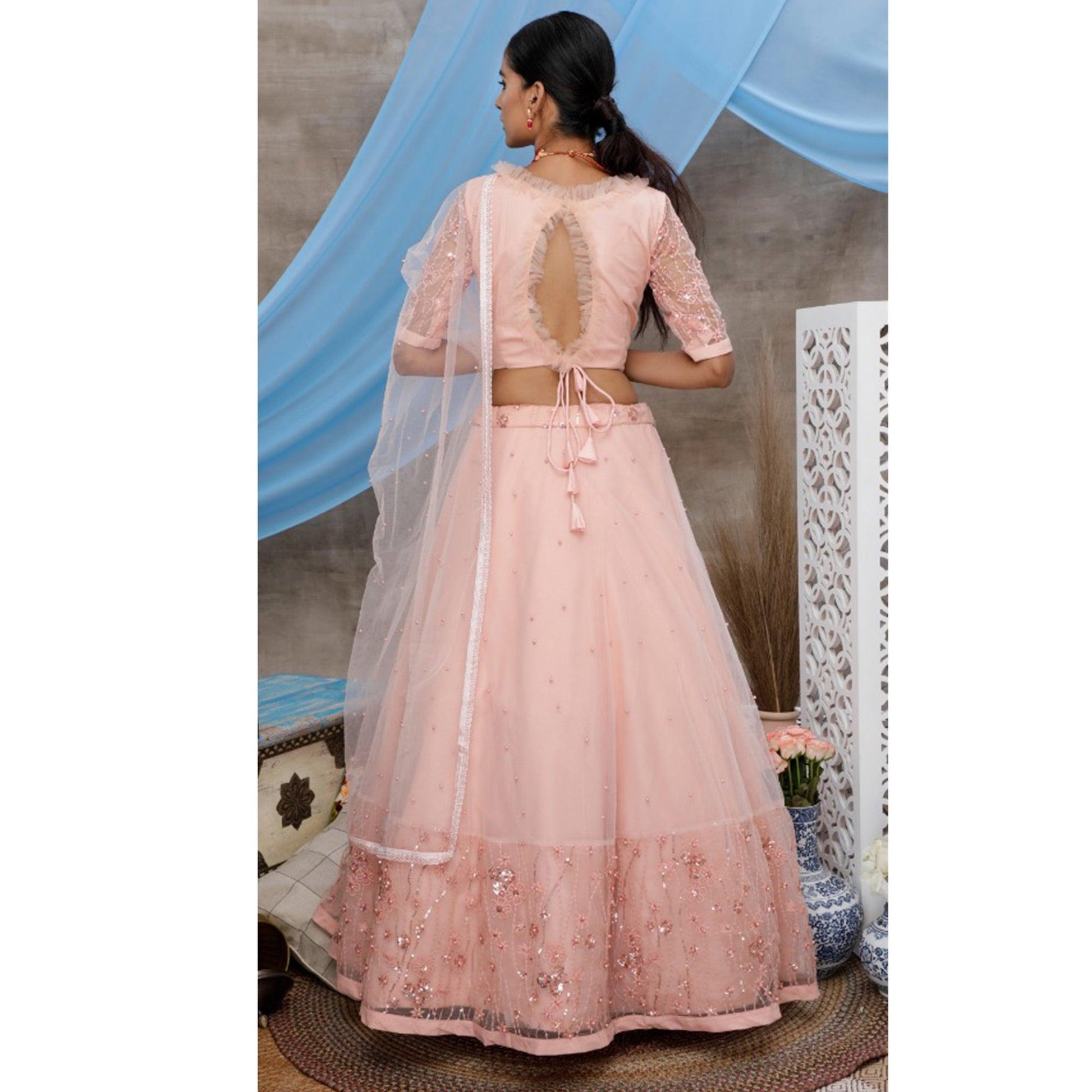 Elegant Peach Colored Party Wear Embroidered Net Lehenga Choli