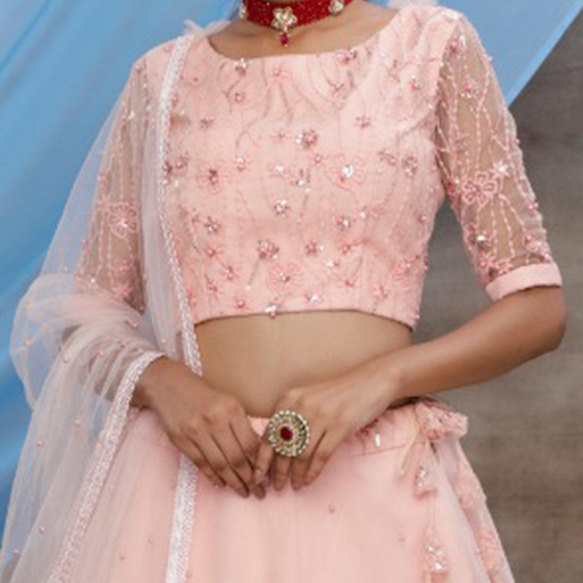 Elegant Peach Colored Party Wear Embroidered Net Lehenga Choli