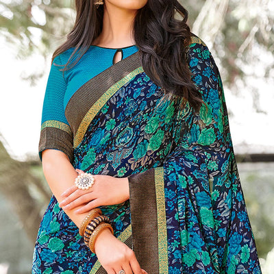 Elegant Peacock Blue Colored Partywear Printed Georgette Saree