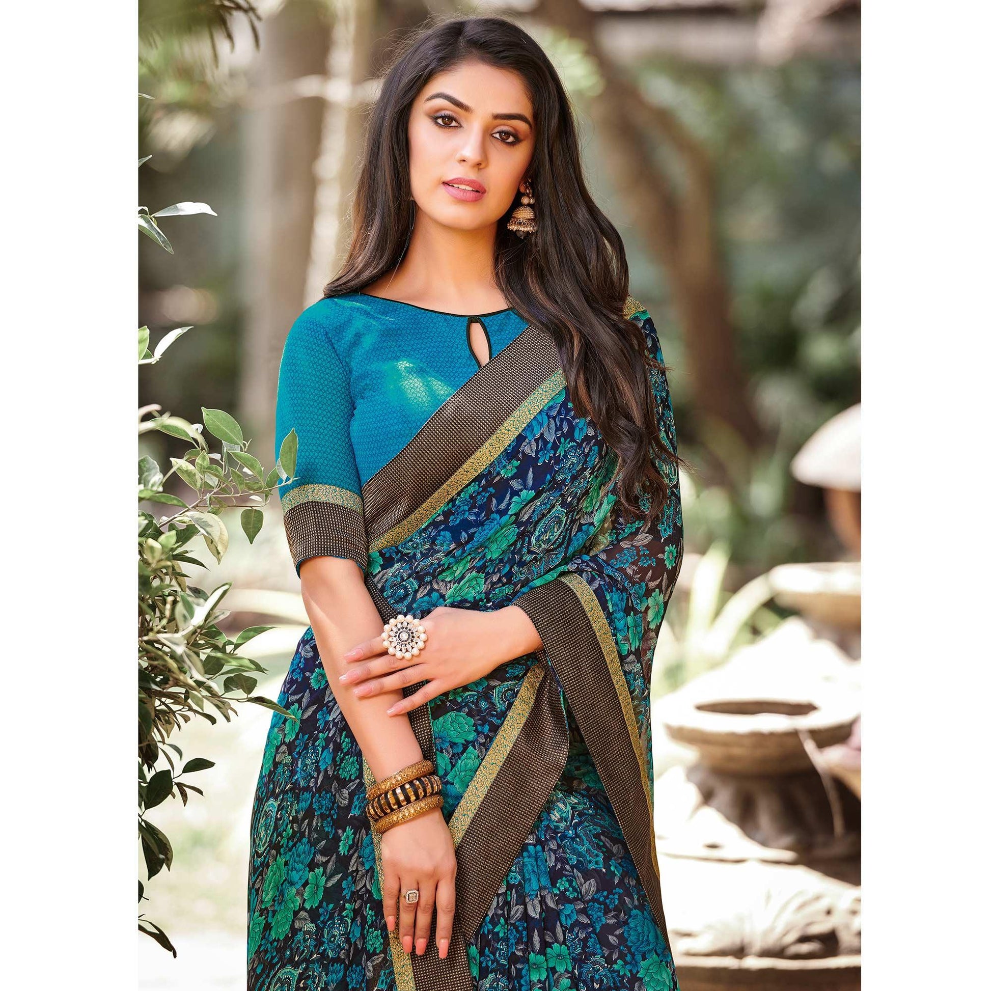 Elegant Peacock Blue Colored Partywear Printed Georgette Saree