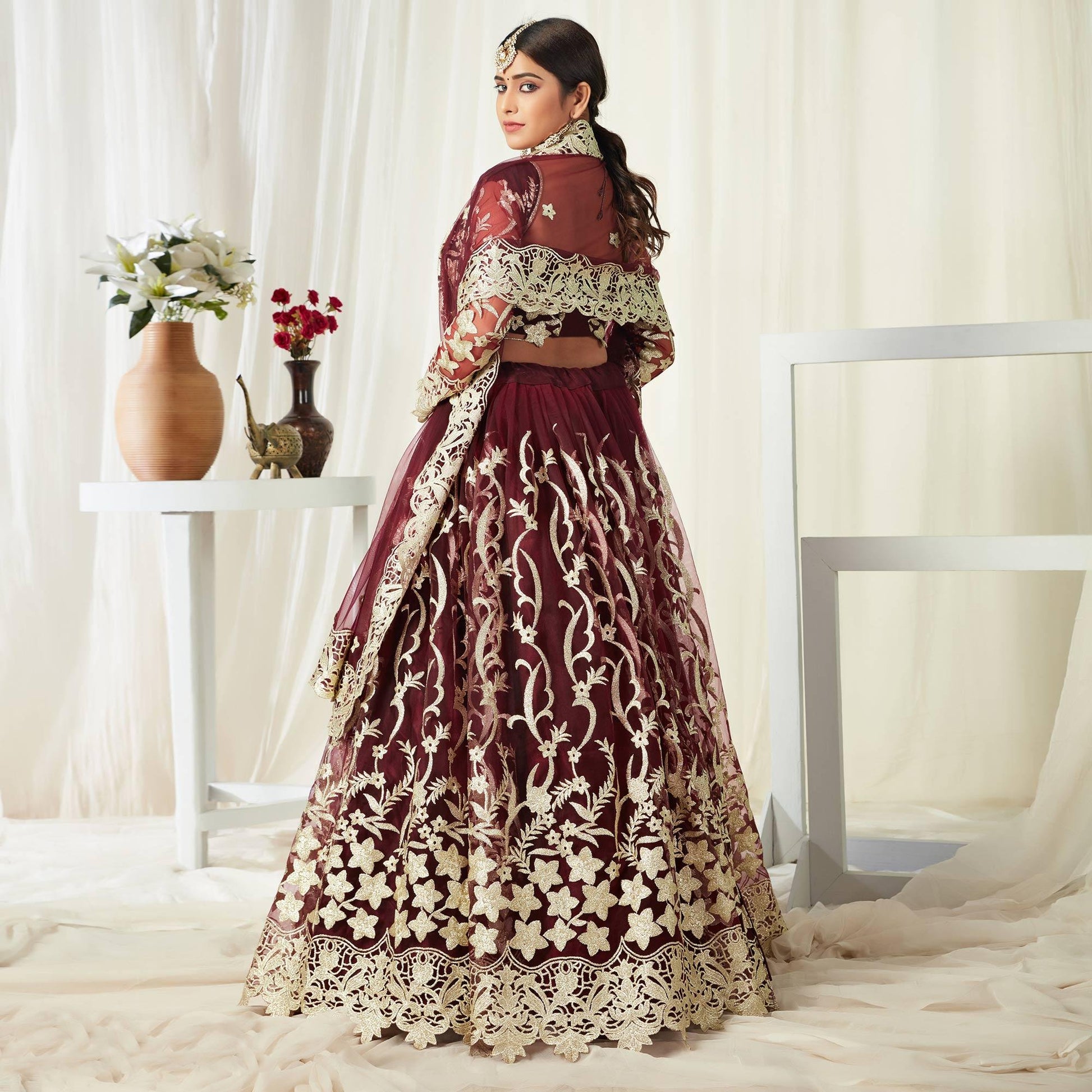 Entrancing Maroon Colored Wedding Wear Butterfly Net With Embroidered Lehenga Choli