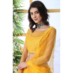 Entrancing Mustard Yellow Colored Partywear Embroidered Netted Lehenga Choli