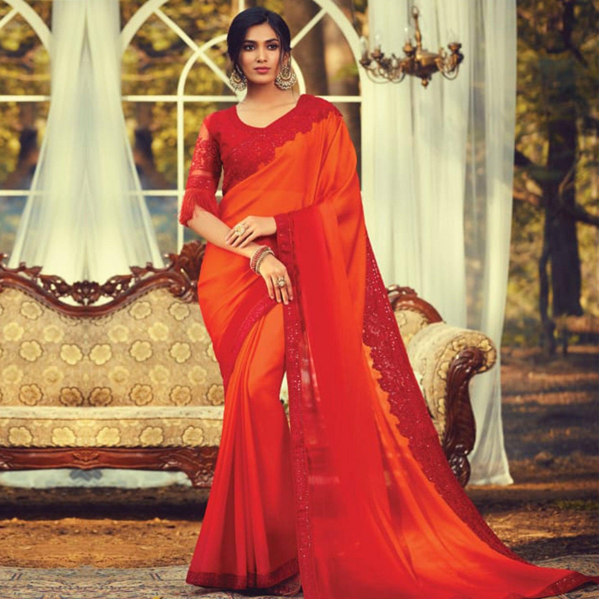 Entrancing Orange Colored Partywear Embroidered Silk Saree