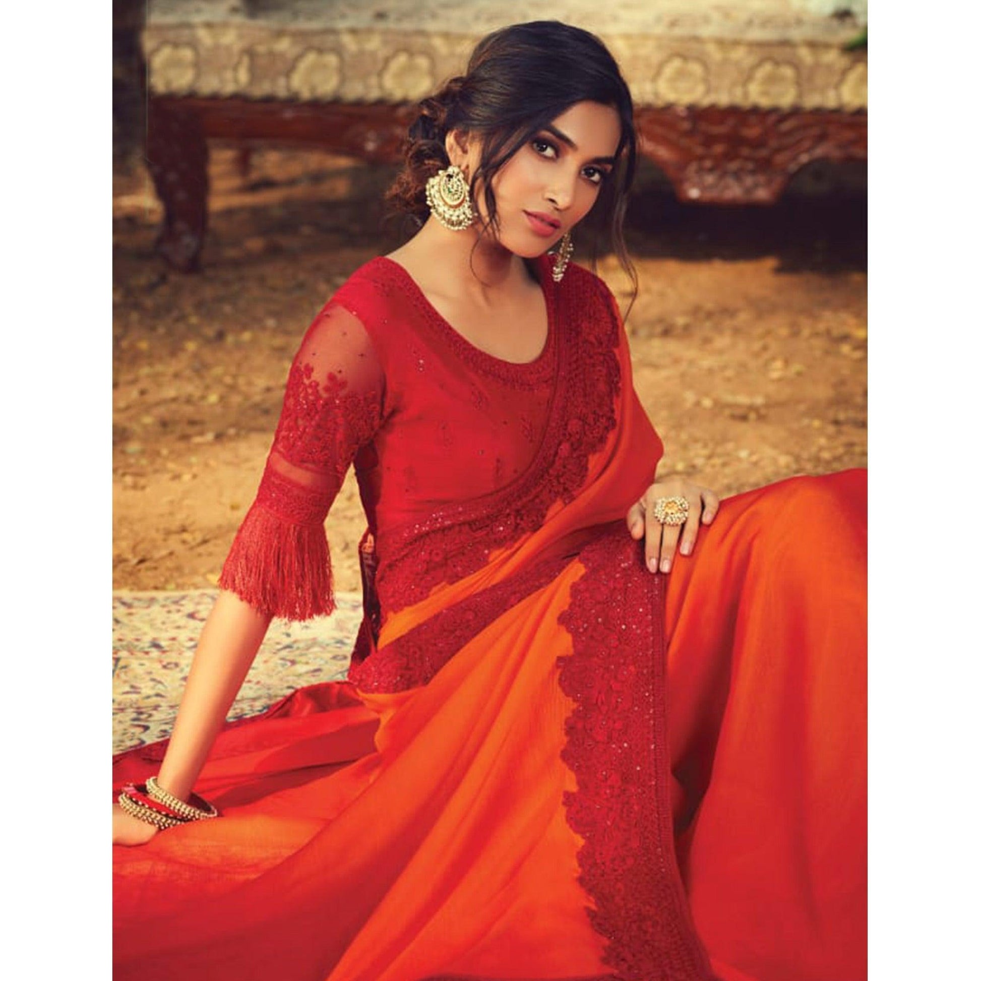 Entrancing Orange Colored Partywear Embroidered Silk Saree