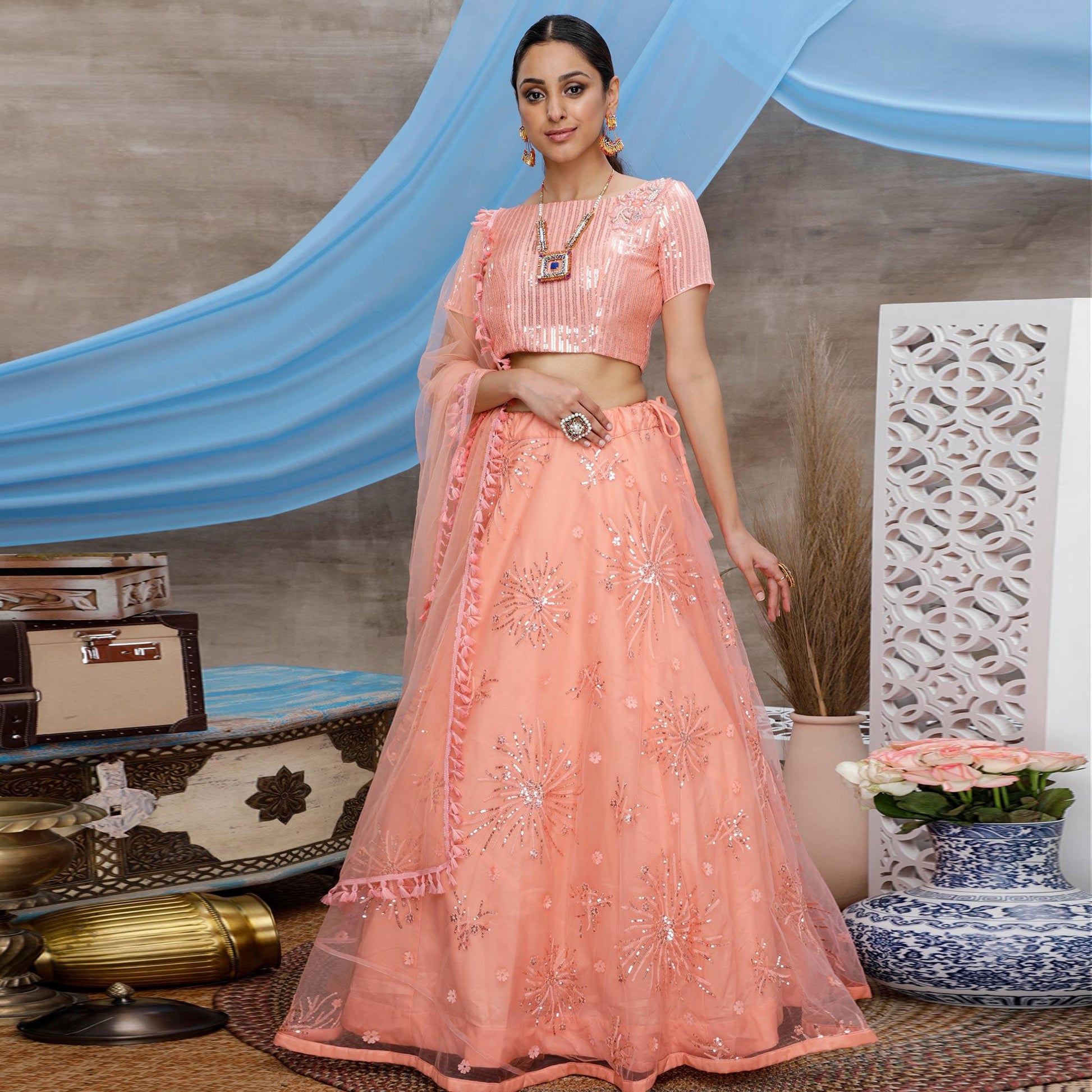 Excellent Orange Colored Designer Partywear Embroidered Net Lehenga Choli