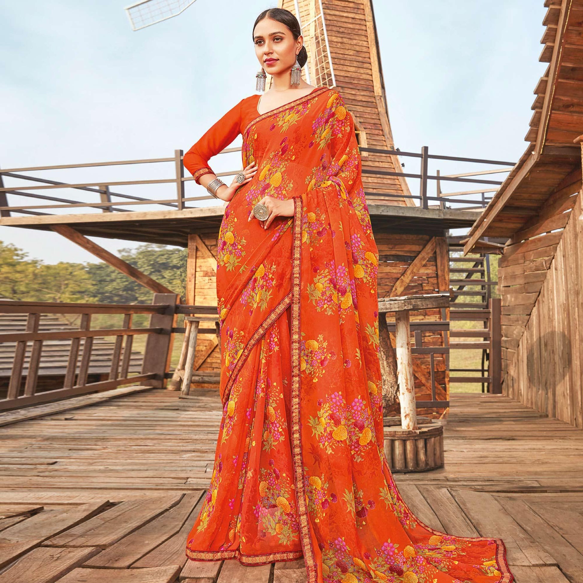 Eye-catching Orange Coloured Partywear Pure Georgette Floral Printed Saree With Fancy Lace Border