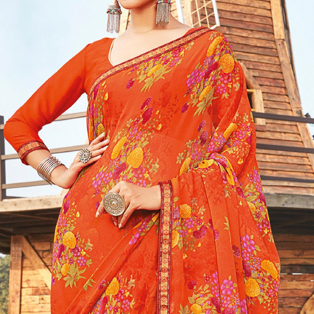 Eye-catching Orange Coloured Partywear Pure Georgette Floral Printed Saree With Fancy Lace Border