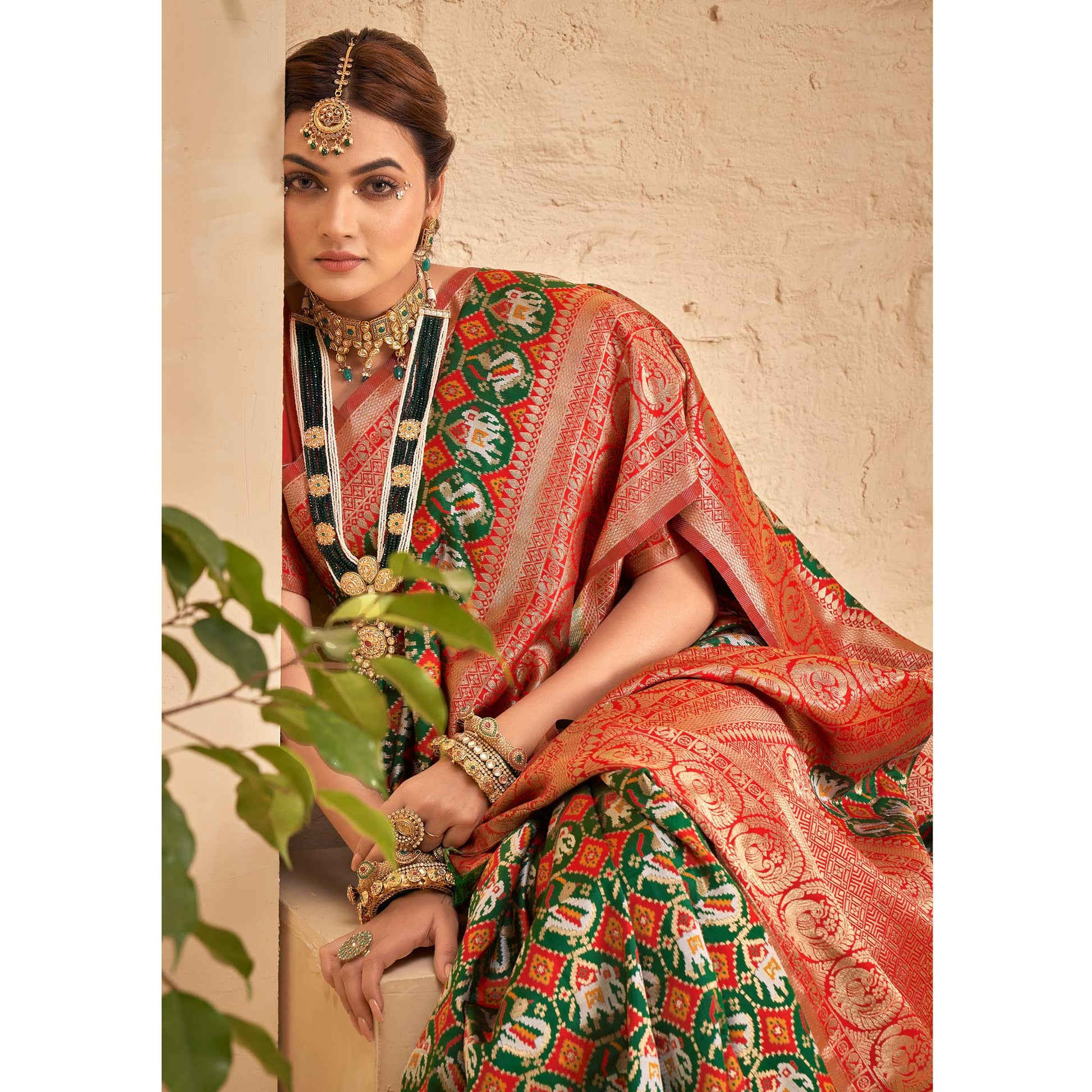 green-woven-patola-art-silk-saree-with-tassels