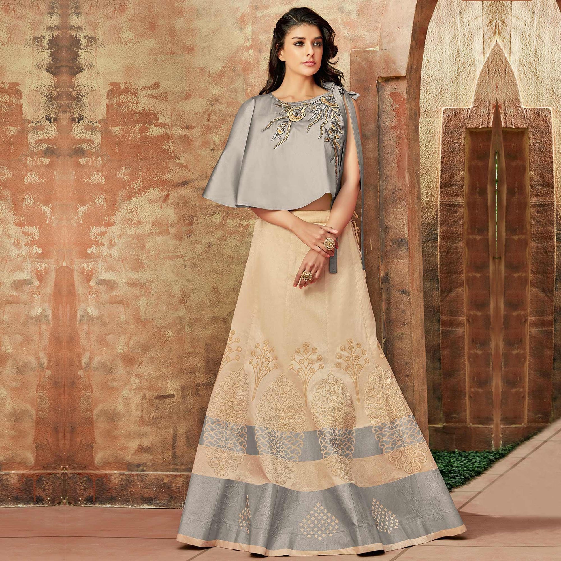 Flirty Cream Colored Partywear Embroidered Silk Lehenga Choli