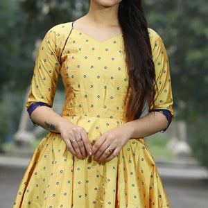 Glowing Light Yellow Colored Partywear Tapetta Gown