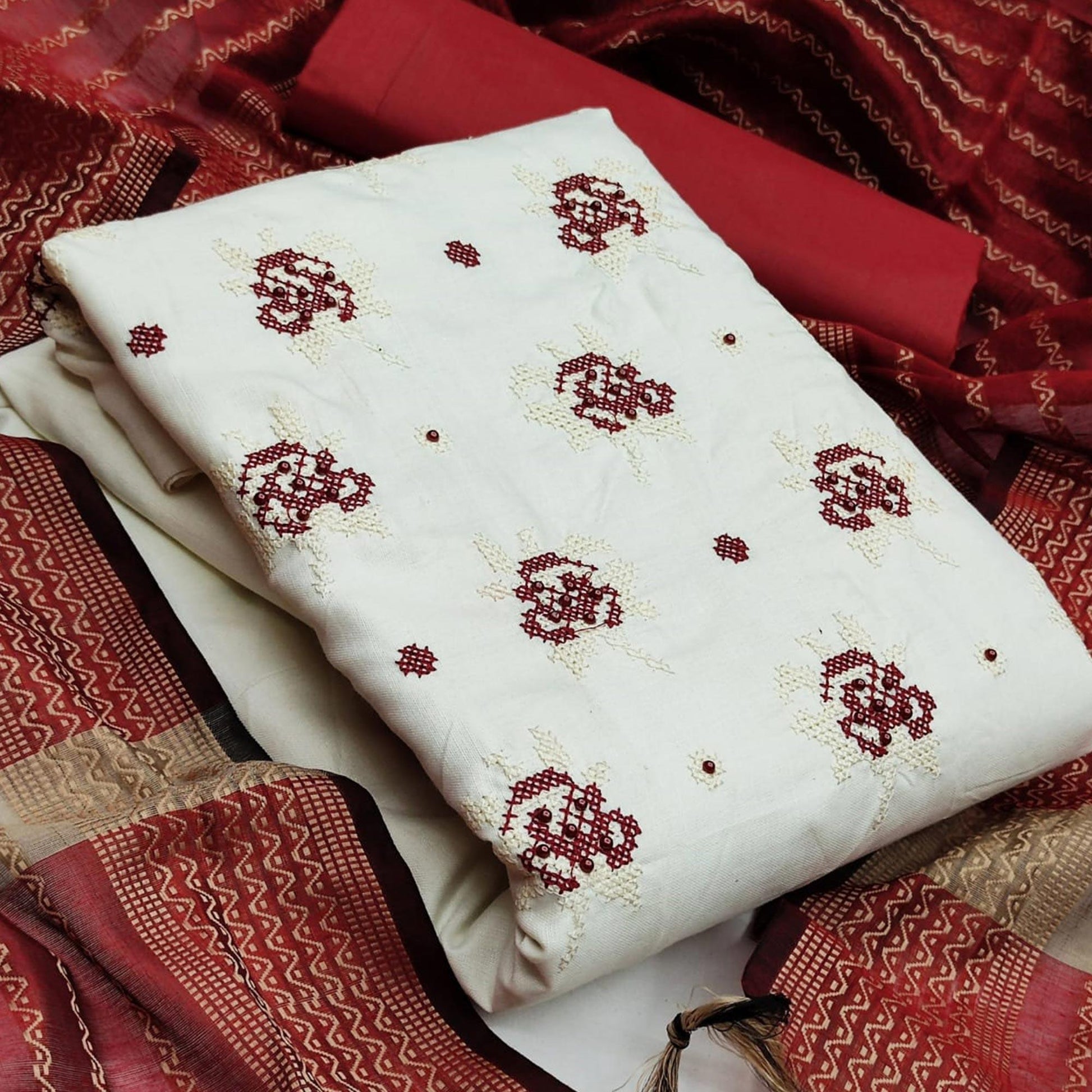 graceful-white-red-colored-partywear-embroidered-cotton-dress-material-104498