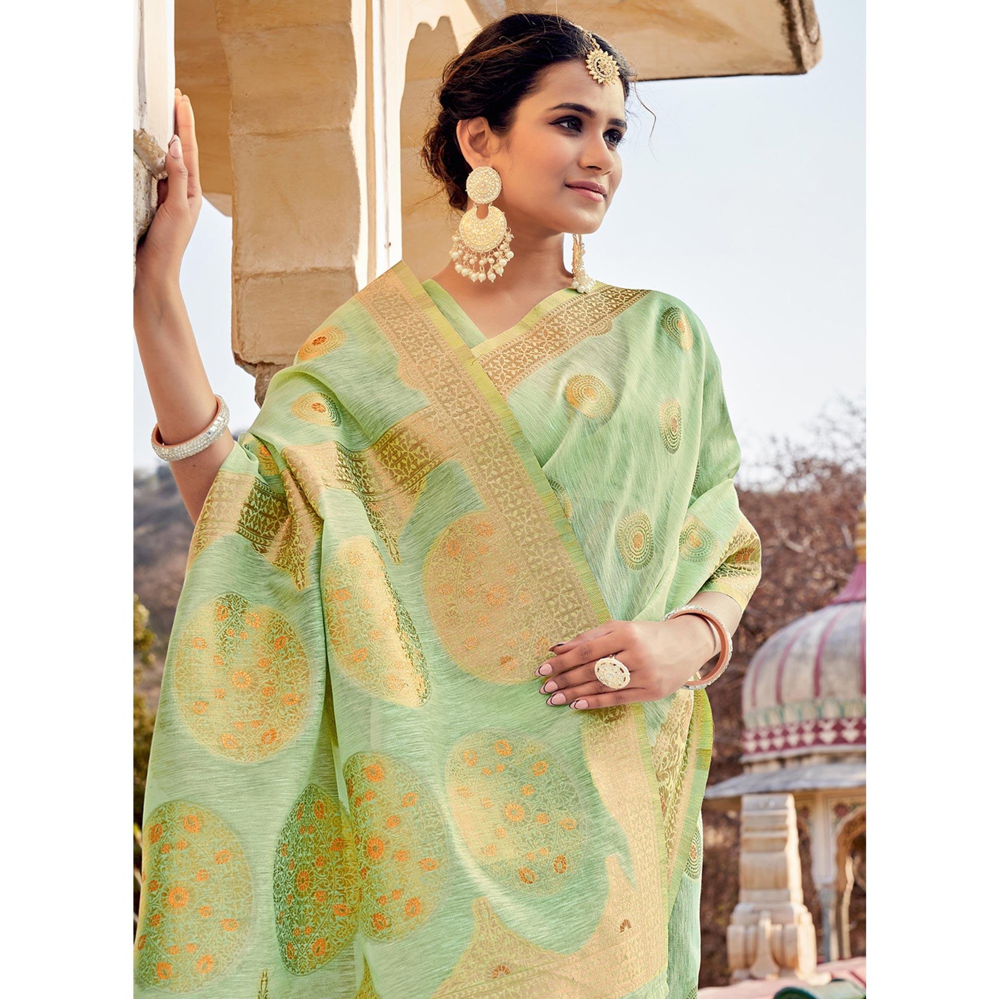 green-festive-wear-weaving-work-linen-saree-with-tassels-139515