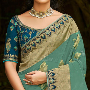 green-festive-wear-woven-embroidered-organza-saree-128554