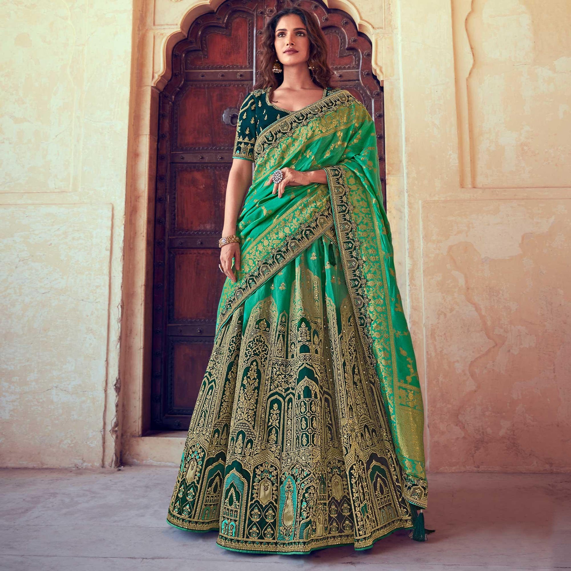 green-wedding-wear-woven-embroidered-silk-lehenga-choli-126744