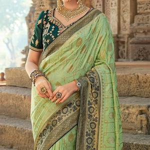 green-festive-wear-woven-silk-saree-with-tassels-138970