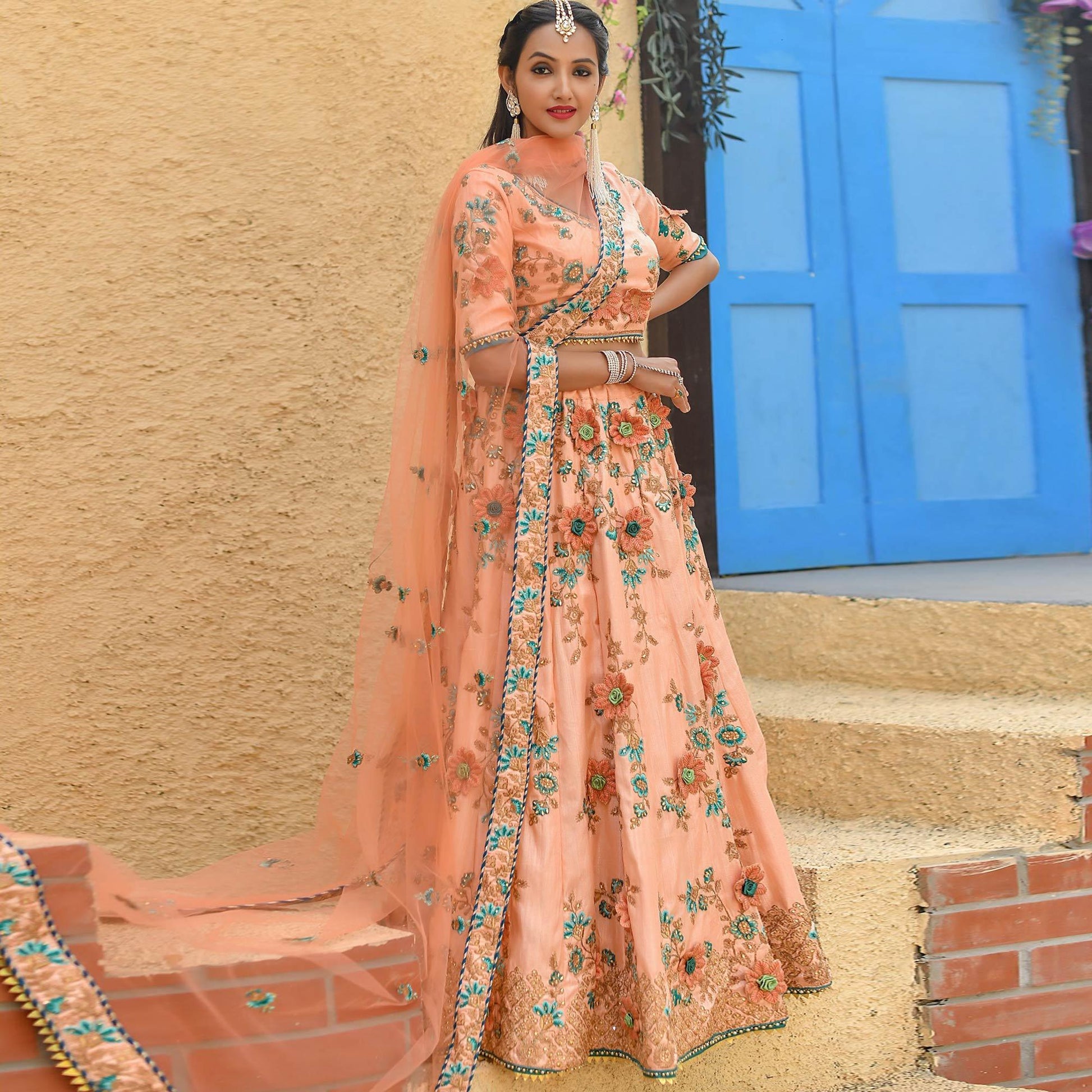 Groovy Peach Colored Partywear Embroidered Silk Lehenga Choli