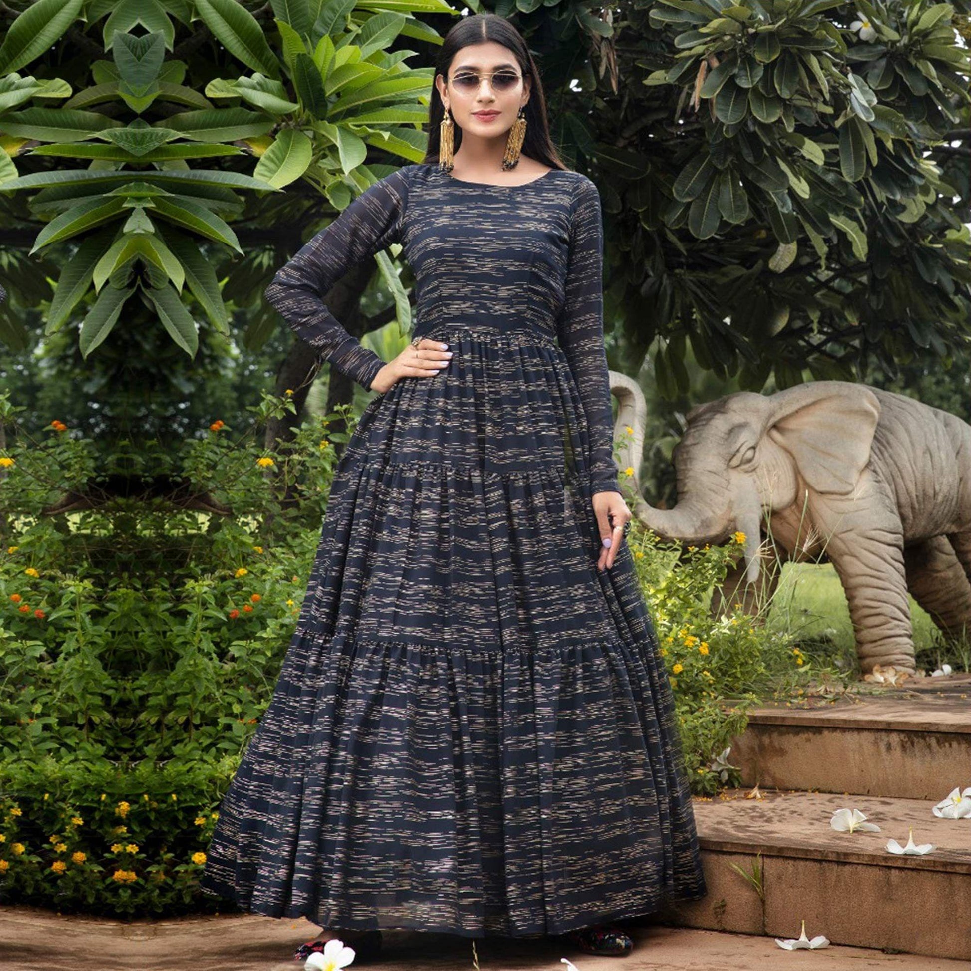Hypnotic Navy Blue Colored Party Wear Foil Printed Georgette Gown