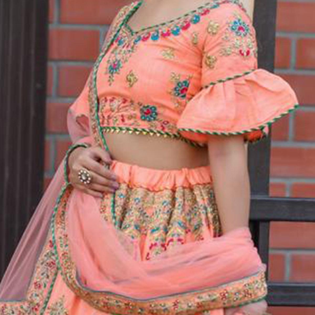 Hypnotic Peach Colored Party Wear Embroidered Silk Lehenga Choli