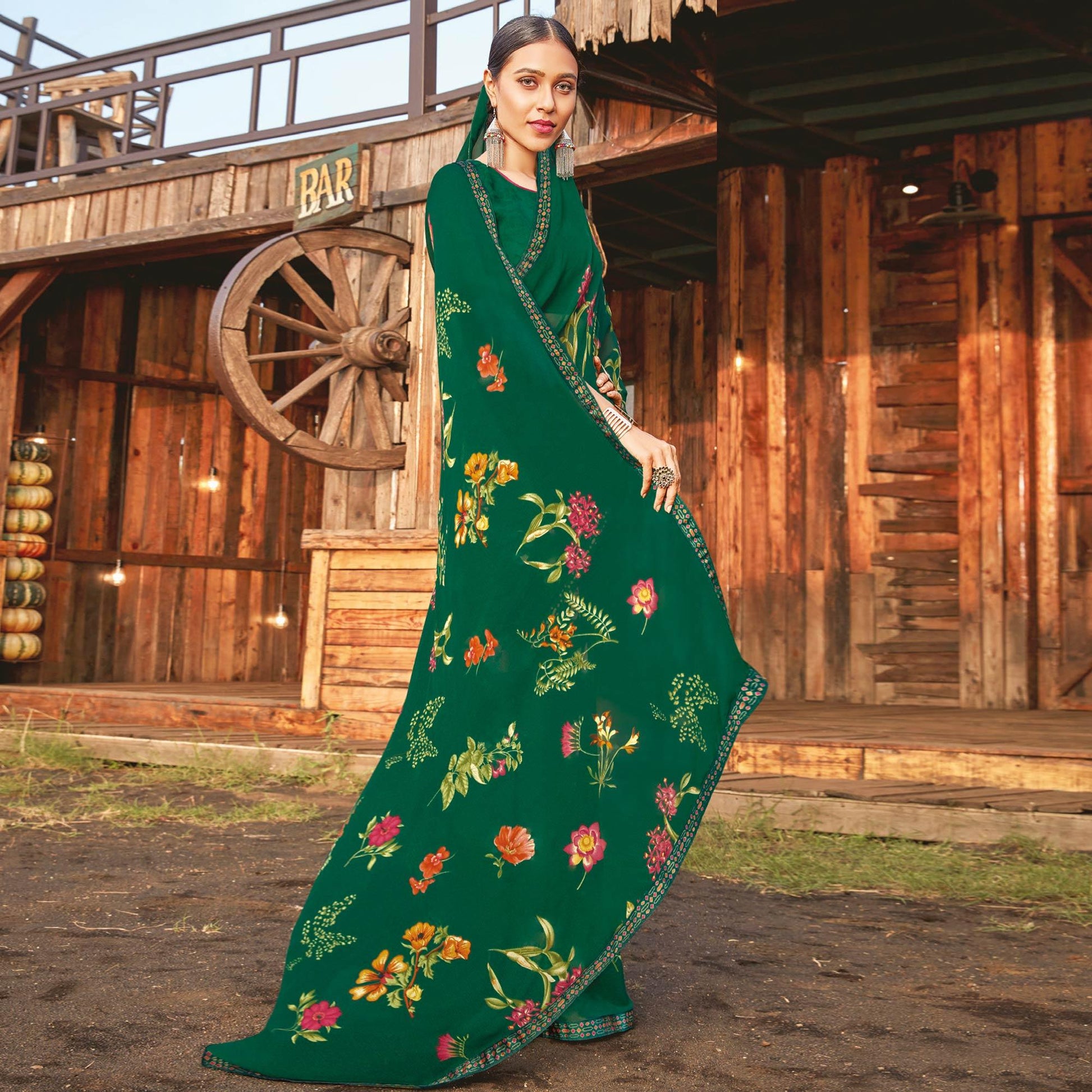Ideal Bottle Green Coloured Partywear Pure Georgette Floral Printed Saree With Fancy Lace Border