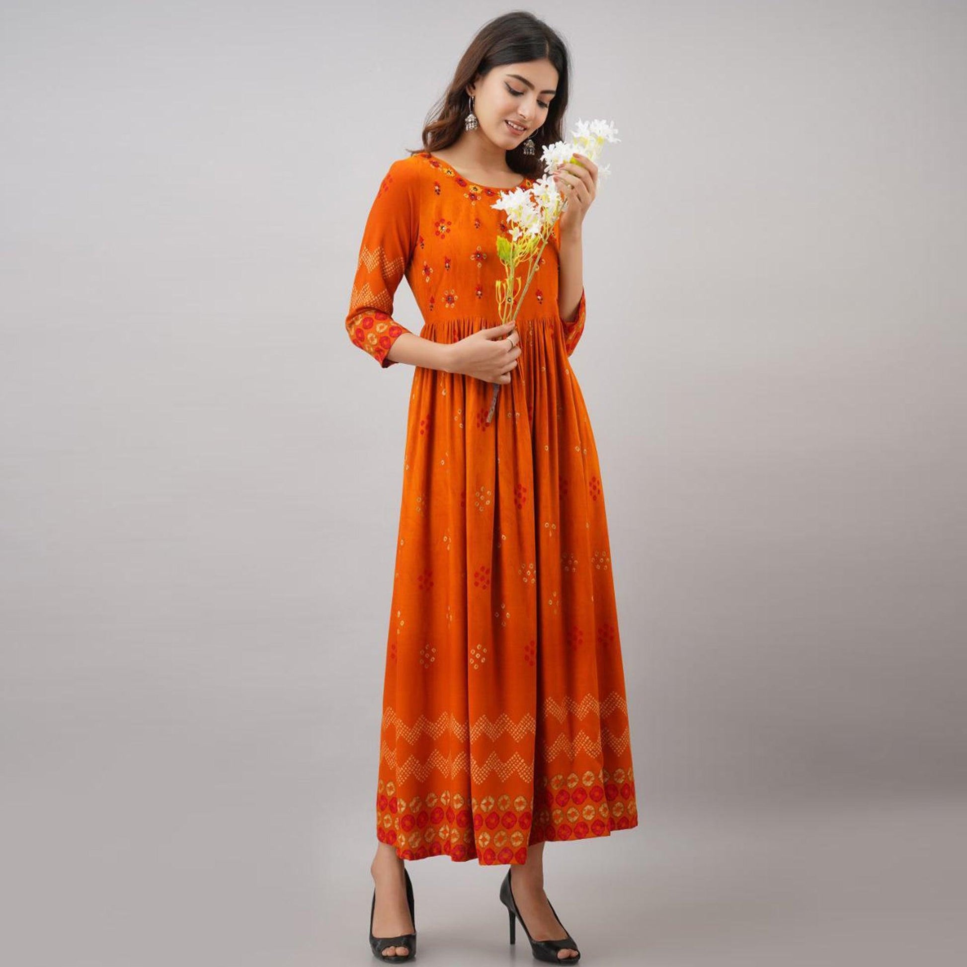Impressive Orange Colored Partywear Embroidered Muslin Long Kurti